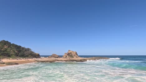 waves crashing on rocks and beach