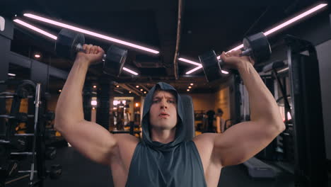 muscular man in 30s performing dumbbell shoulder press at futuristic gym - close-up front view