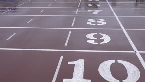 rainy day, athletics track in the stadium. the ground is marked with runways 6 to 10.