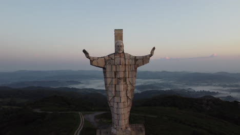 Reveal-of-a-religious-statue-made-of-concrete-at-the-top-of-a-mountain