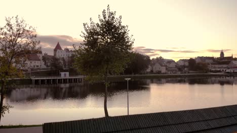 small graduation tower near pond, a place for recreation and treatment with benches and graduation towers, a spa with walking paths in the middle of a small village by the water