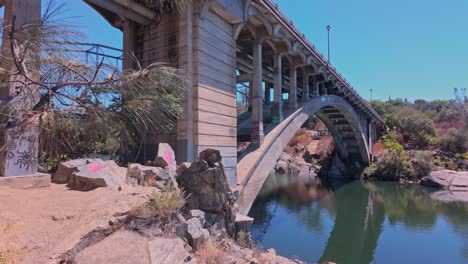 a cinematic panning shot of the folsom historic truss bridge in california. the steel structure spans the american river