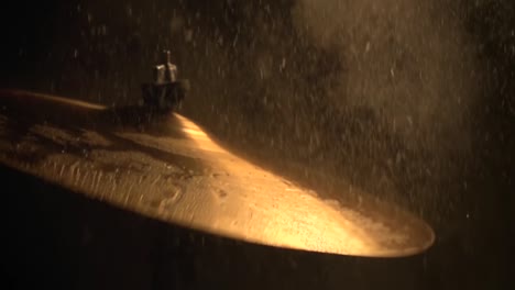 a slow motion of water drops falling on cymbals