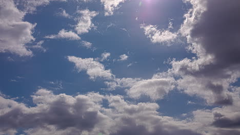 dense clouds rolling over sunny sky during sunset