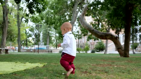 first steps curious little boy walking barefoot on green grass outdoors