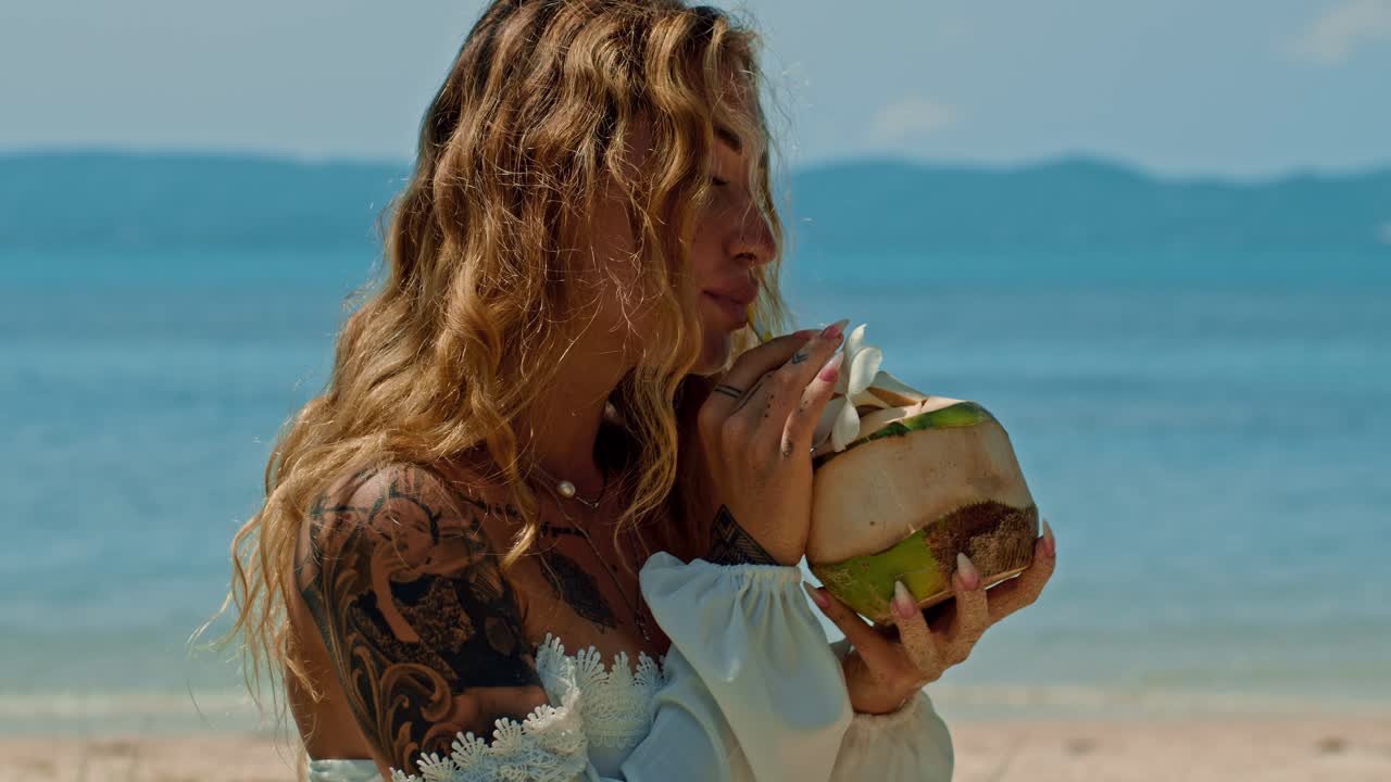 Woman Drinking Coconut Water on Beach