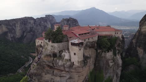 close aerial arc of impressive monastery of varlaam atop rock monolith, meteora