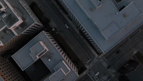 overhead drone shot following a car driving through the streets of residential blocks in the evening, empty streets of atlanta, georgia, usa