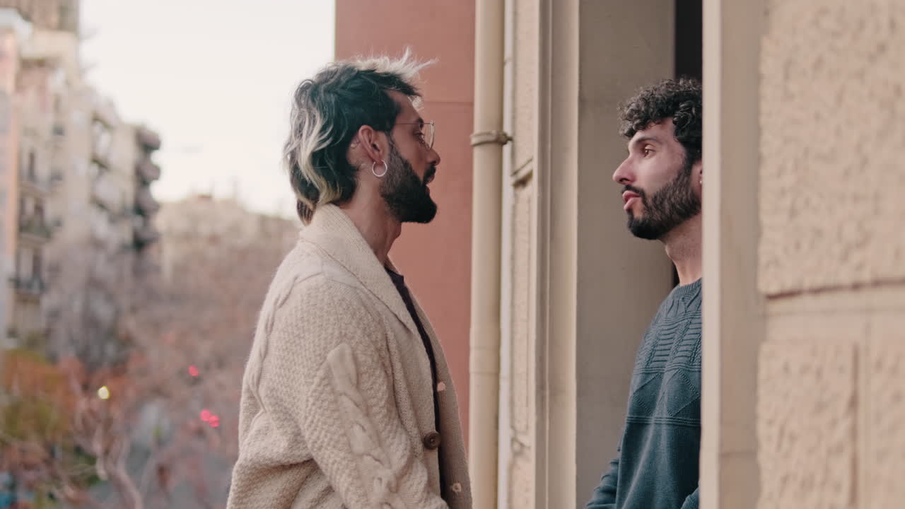 Gay Couple Holding Hands on Balcony