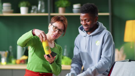 Cheerful-Black-Deliveryman-Unloading-Healthy-Food-for-Woman