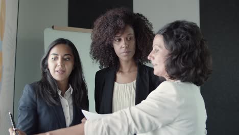 content businesswomen standing and discussing project