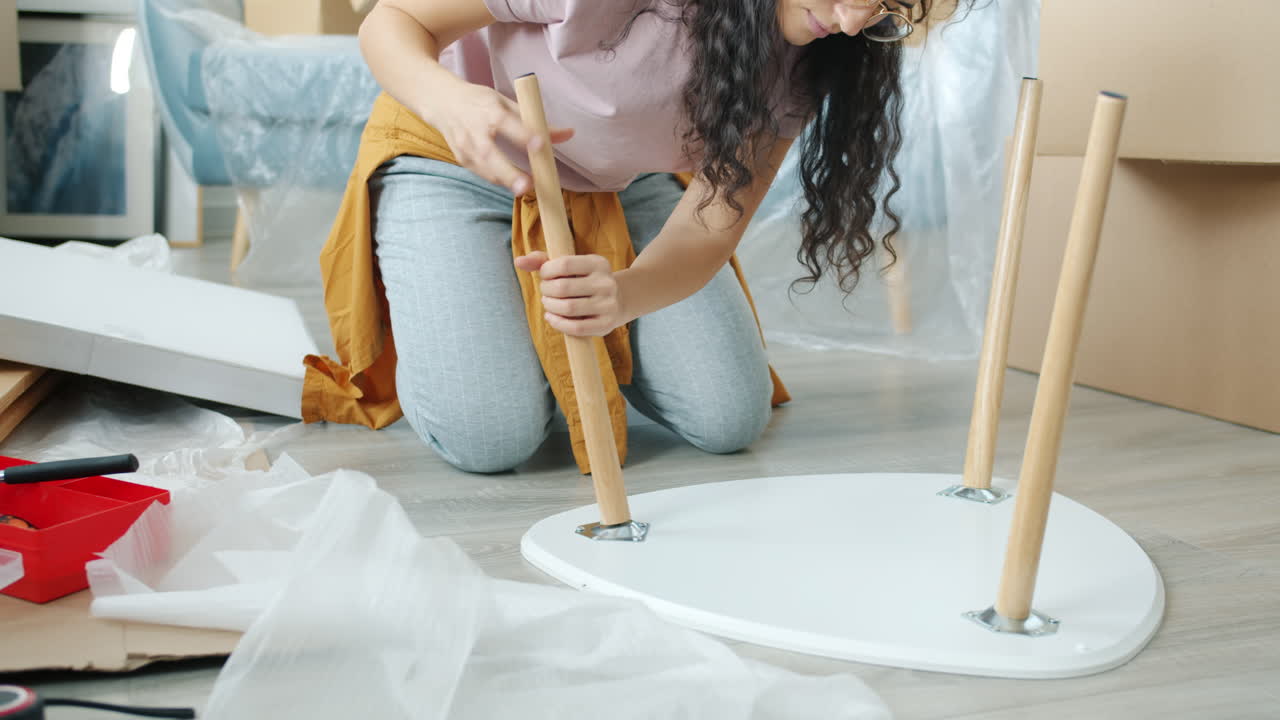 Woman Assembling a Small White Coffee Table