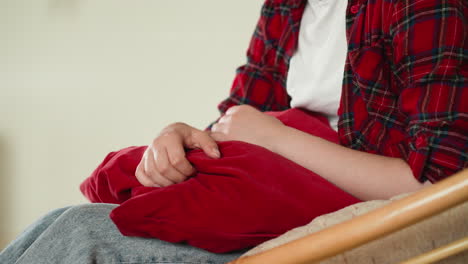 lady clutches soft cushion due to mental pain. non-verbal expression conveying depth of woman struggle with mental health challenges at home