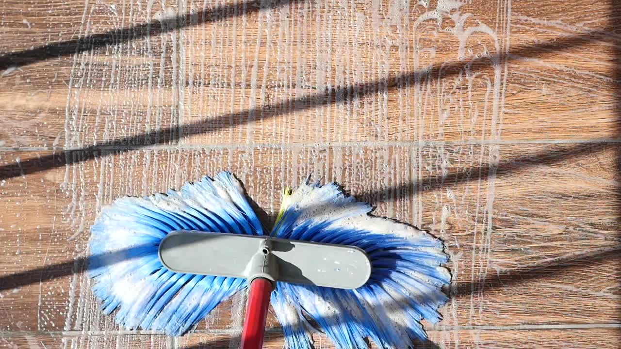 Cleaning a Tiled Floor with Soap and Water