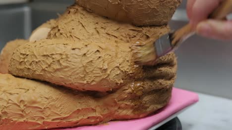 close-up-of-pastry-chef-icing-a-children's-birthday-cake