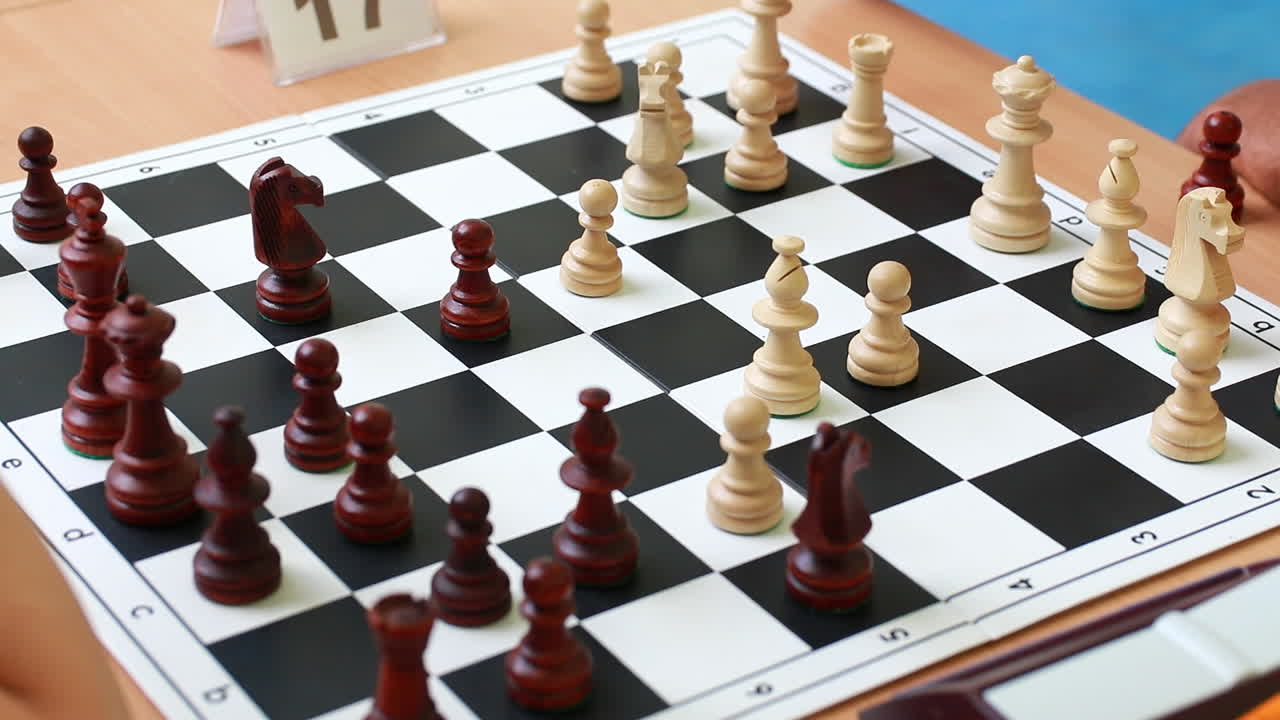 Serious man is making his move while playing chess. Logic developing board game concept. Cropped view