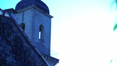 stone bell tower between historic house and nature in france boulbon