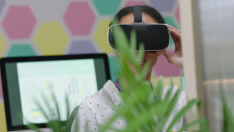 happy business woman wearing virtual reality headset enjoying entertainment on lunch break eating pretzels in colorful modern office workplace