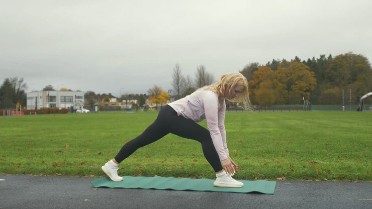 Woman practicing Low Lunge Yoga Pose outdoor