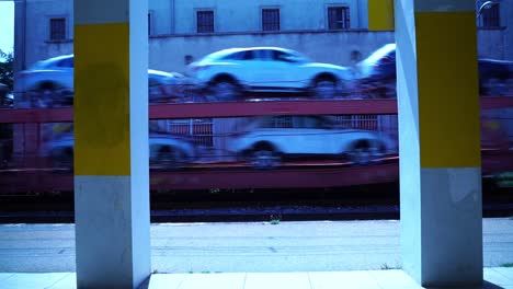 freight train loaded with cars passes through an empty keline train station in france