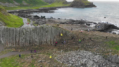 aerial dolly of tourists visiting the giant's causeway in northern ireland