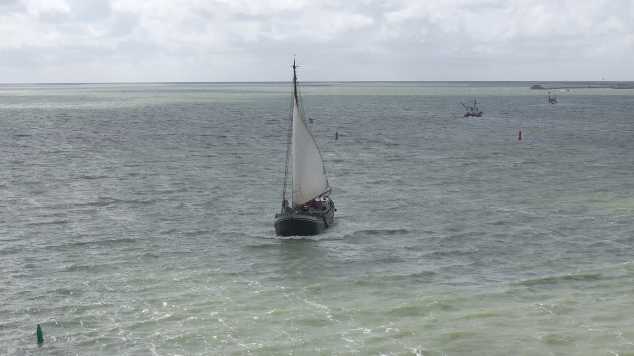 Old dutch sail vessel sailing on Ijsselmeer near Makkum, aerial