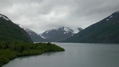 4K-Aerial-drone-footage-of-riverfront-open-water-and-mountains-in-Alaska-during-summertime