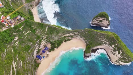 aerial view of kelingking beach, bali. controversial construction site with crane building lift.