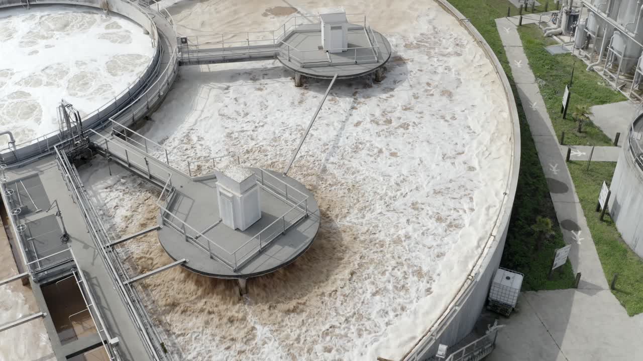 Aerial close-up view of water aeration process in circular treatment tank at industrial facility, Veille-Saint-Girons, France