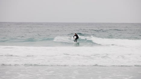 White-Surfer-in-Black-Wetsuit-Catching-Wave-in-Monterey-Bay-California