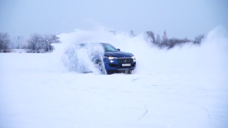 blue suv drifting on snow