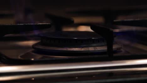 close up of gas hob ring igniting to flame on cooker then turning off