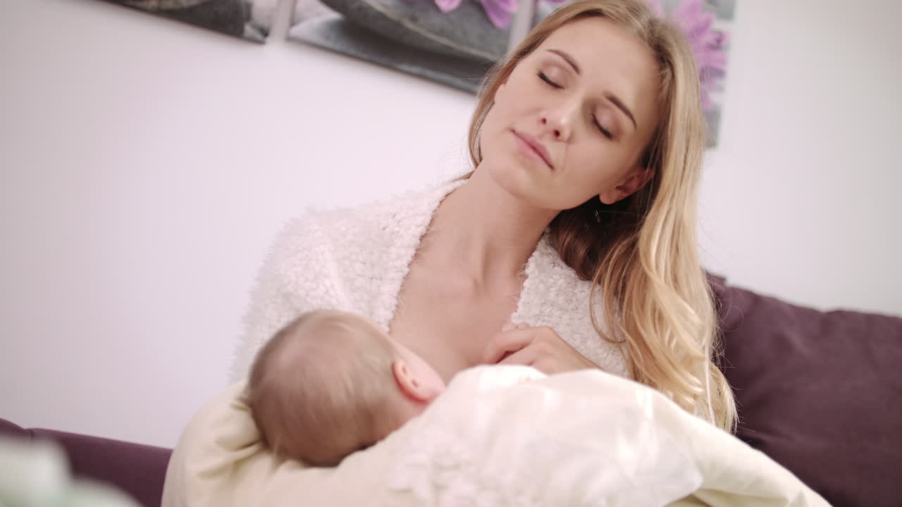 Beautiful Mom Breastfeeding Baby. Dreamy Mother Breastfeeding Daughter Free Stock Video Footage Download Clips 