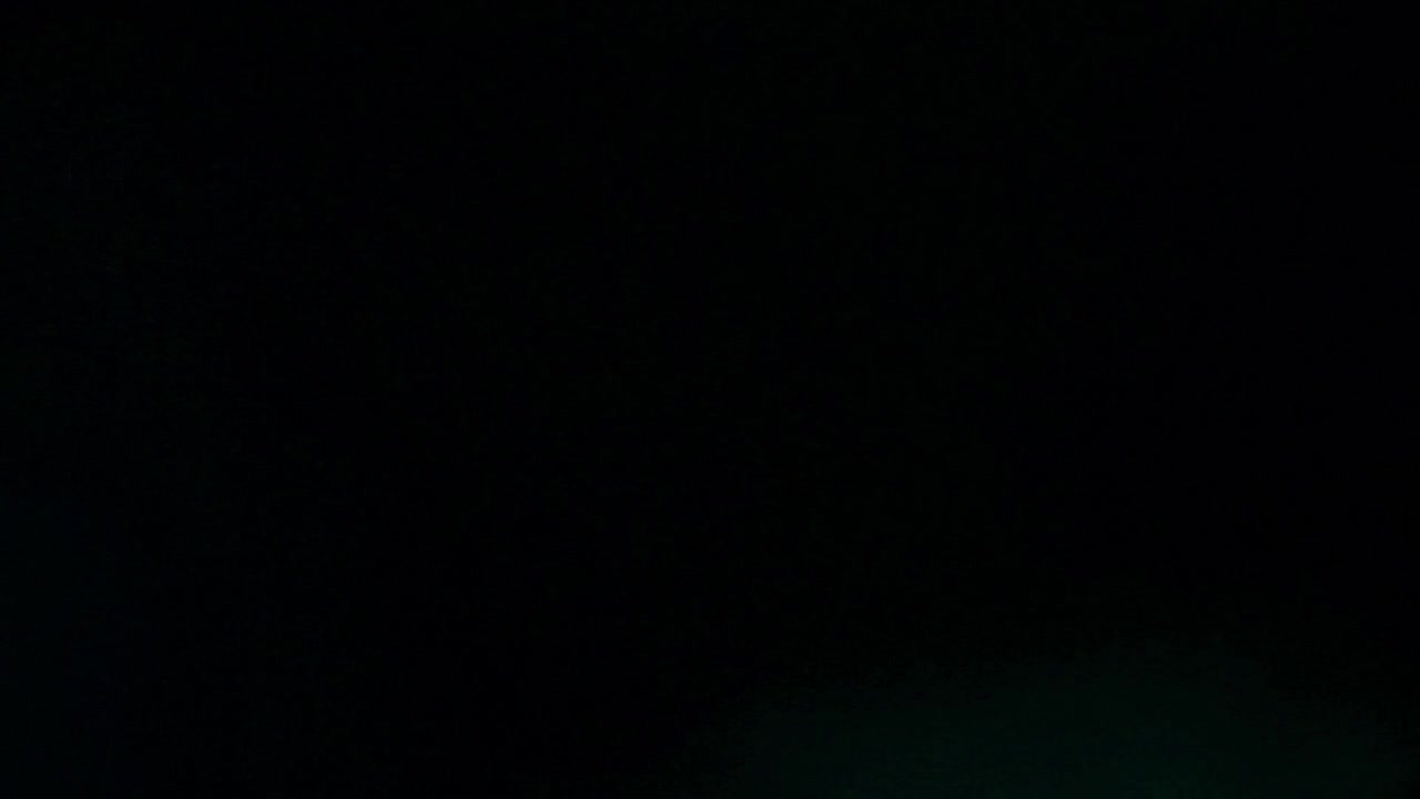 Abstract Blue Light Flare Moving Across Dark Screen