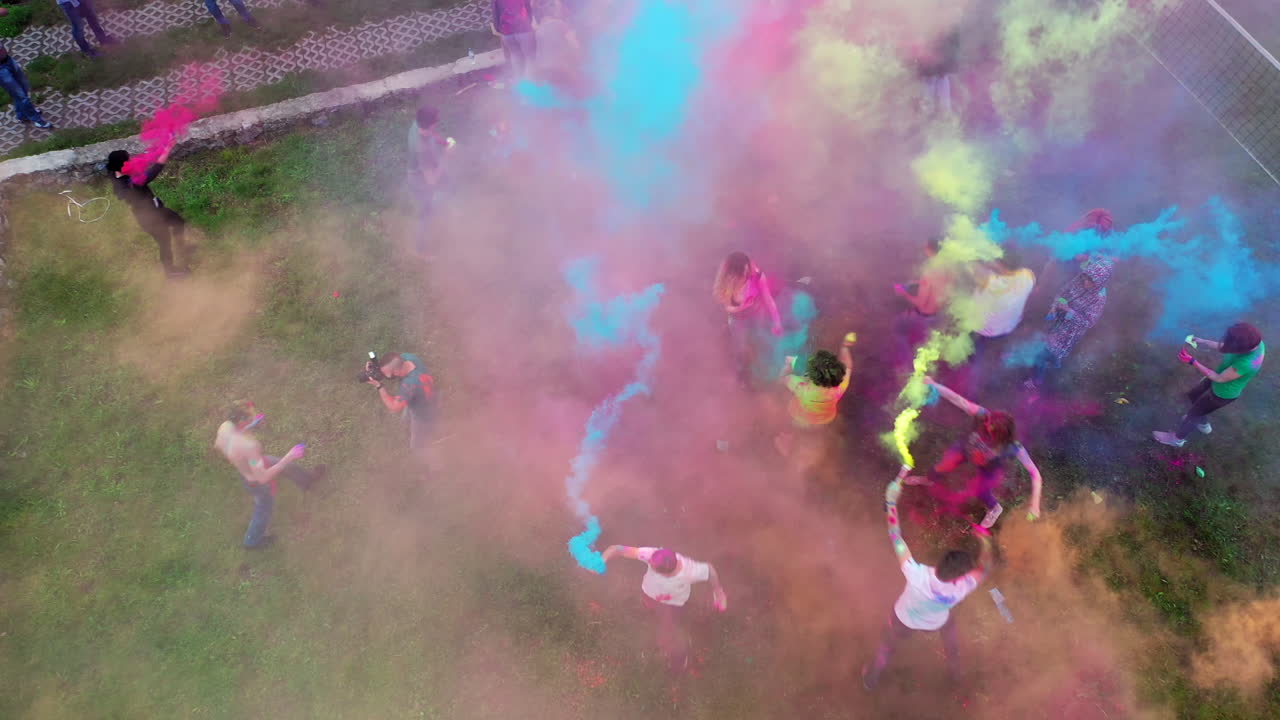People covered with colored powder. Happy young people dancing and celebrating during music and colors festival