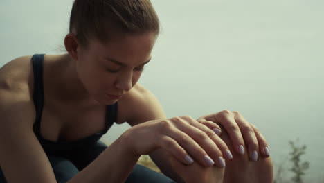 yoga woman making exercises on sea beach closeup. relaxed girl stretching body.