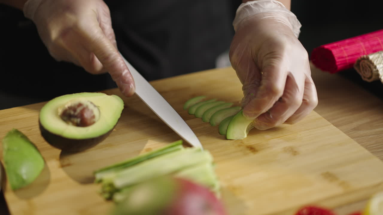 Slicing Fresh Avocado on a Wooden Cutting Board