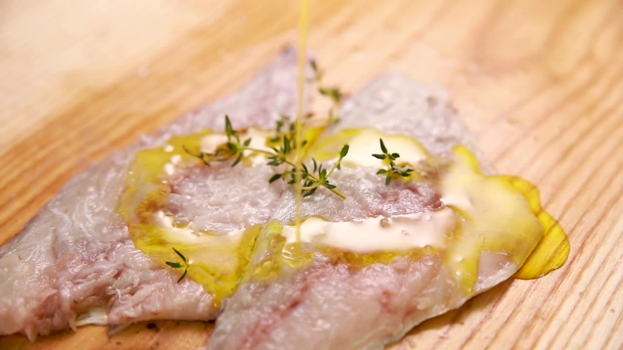 올리브 오일과 허브로 생선 필레를 준비합니다.