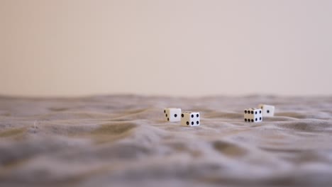 white dice sitting on gray felt