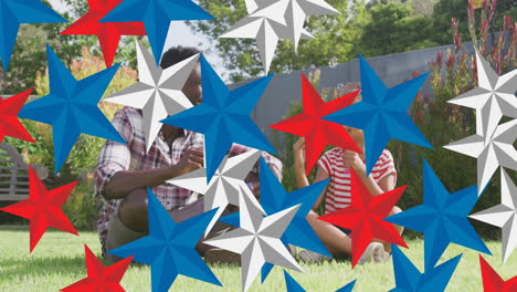 animation of red, blue and white stars over african american father and daughter having fun