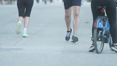 people walking and running on a city street