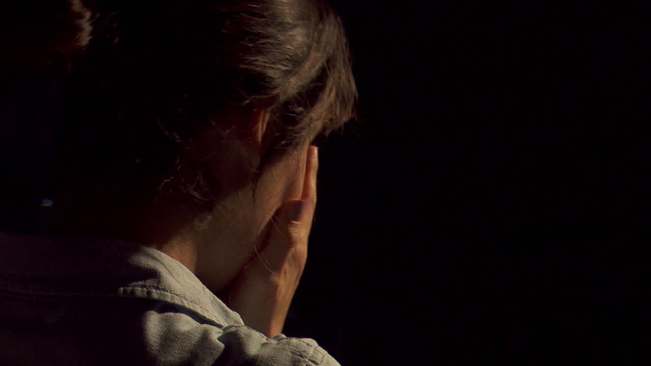 Woman with head in hands