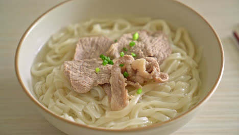 homemade udon ramen noodles with pork in clear soup