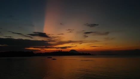 a 60 fps panning video of a beautiful sunset with a volcano in the background