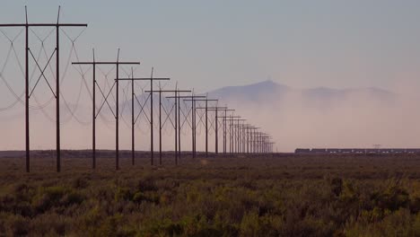 a train travels in the distance across a desert