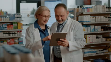 pharmacists collaborating with a digital tablet in a pharmacy