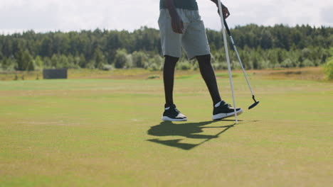 african american man practicing golf on the golf course.