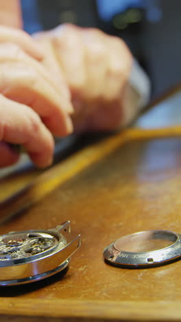 close-up of horologist repairing a watch