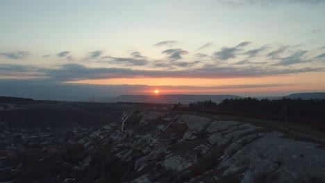 sunrise over a mountainous landscape with city views