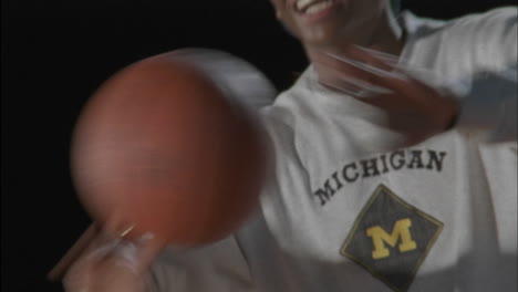 three men play basketball